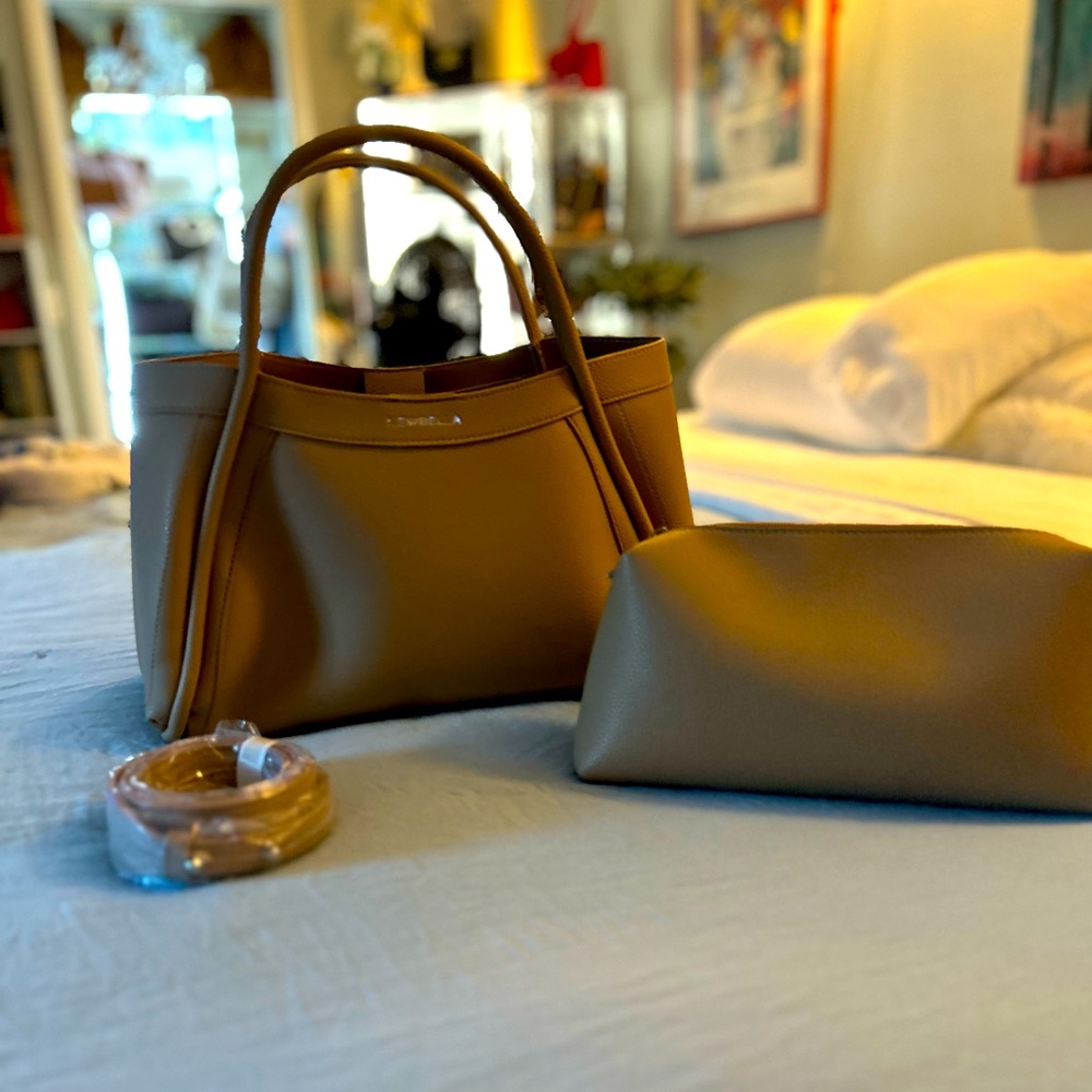 NewBella tan colored tote with shoulder strap and extra bag faux leather.